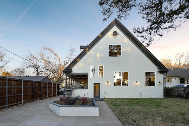 view of front of home featuring a patio area and a lawn