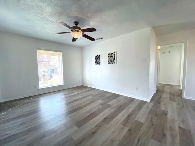 unfurnished room featuring hardwood / wood-style floors, a textured ceiling, and ceiling fan