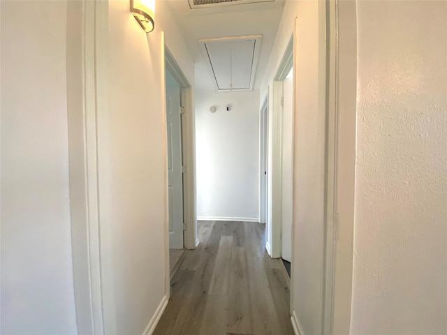 corridor with hardwood / wood-style flooring