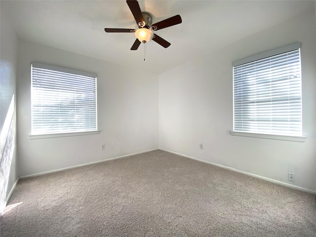 unfurnished room featuring ceiling fan and carpet floors