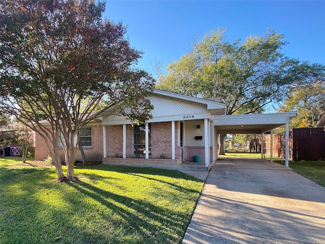 view of front of property with a carport and a front lawn