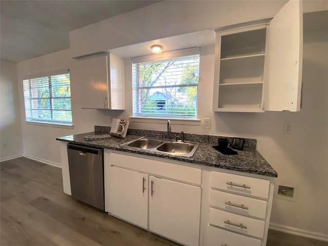 kitchen featuring a wealth of natural light, dishwasher, sink, and white cabinets