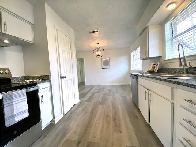 kitchen with stainless steel range with electric stovetop, wood-type flooring, a textured ceiling, and white cabinets