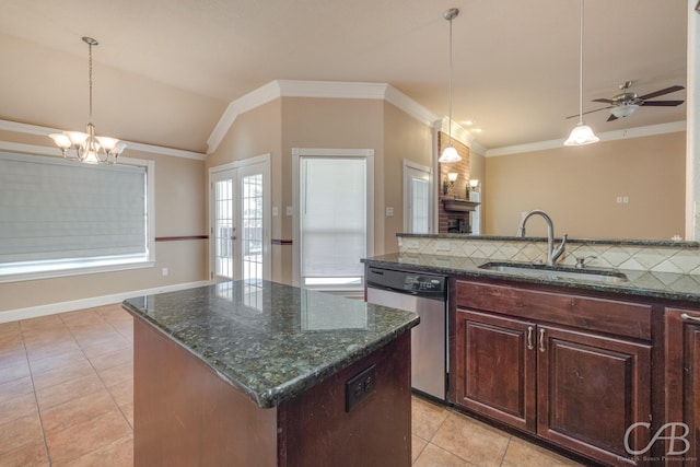 kitchen featuring dark stone countertops, hanging light fixtures, dishwasher, and a kitchen island