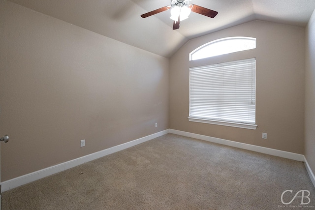 empty room with lofted ceiling, light carpet, and ceiling fan