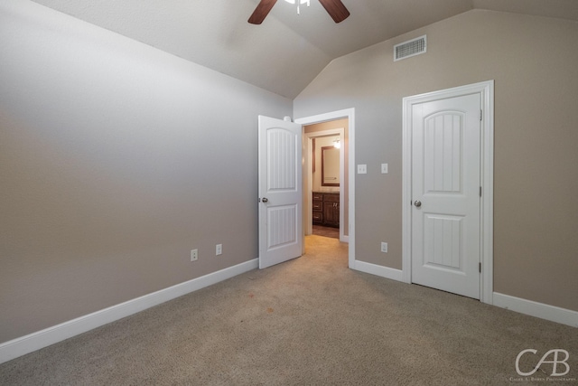 unfurnished bedroom with lofted ceiling, light carpet, and ceiling fan