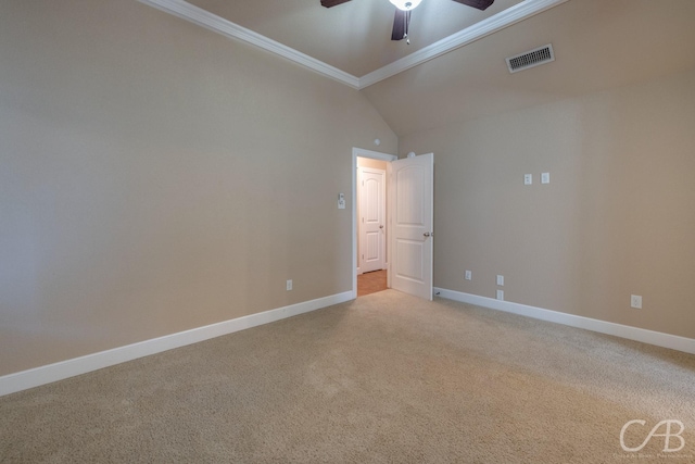 carpeted spare room featuring ceiling fan, ornamental molding, and vaulted ceiling