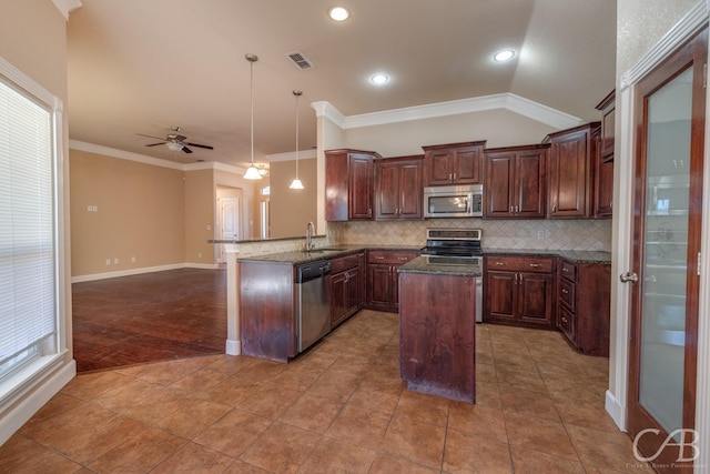 kitchen with pendant lighting, appliances with stainless steel finishes, ornamental molding, decorative backsplash, and kitchen peninsula