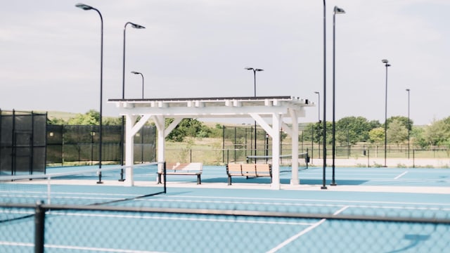 view of tennis court featuring a pergola