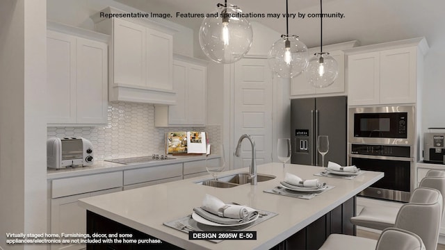 kitchen with sink, hanging light fixtures, white cabinets, stainless steel appliances, and backsplash