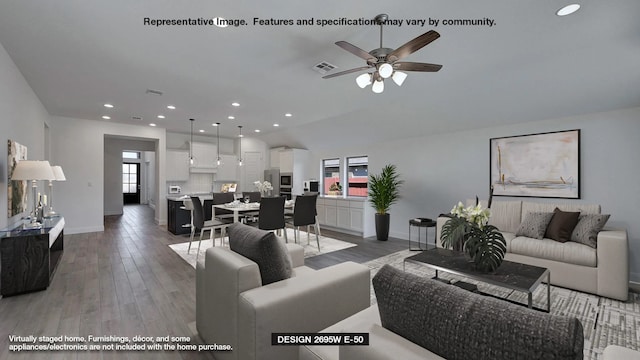 living room with ceiling fan and wood-type flooring