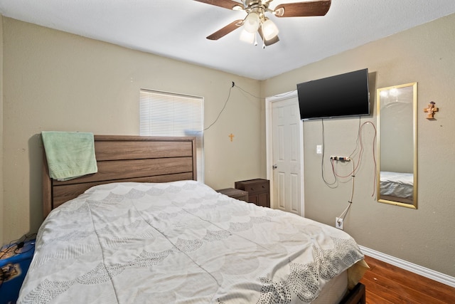 bedroom with hardwood / wood-style flooring and ceiling fan