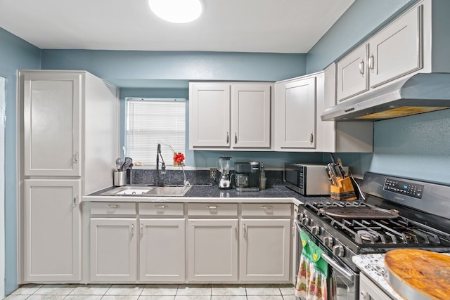 kitchen with white cabinetry, appliances with stainless steel finishes, sink, and light tile patterned floors