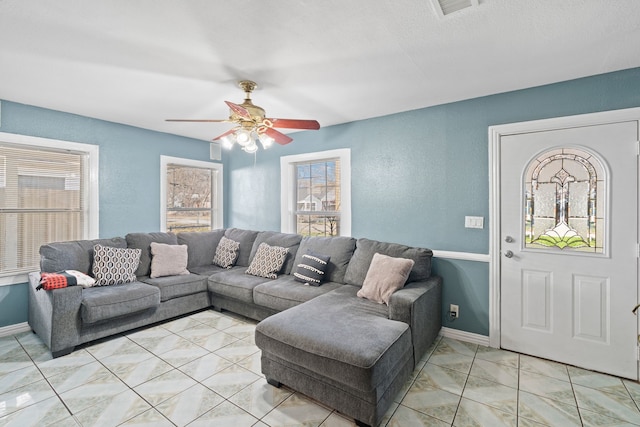 living room with ceiling fan and light tile patterned floors