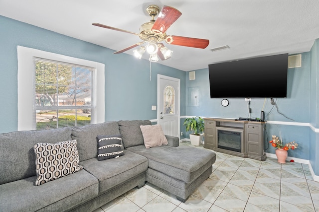 tiled living room featuring ceiling fan