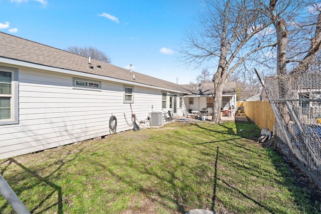 back of property with a yard, a patio, and central air condition unit