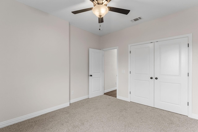 unfurnished bedroom featuring a closet, ceiling fan, and carpet