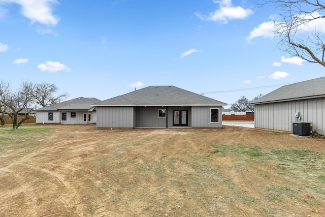 back of property with a yard and central air condition unit