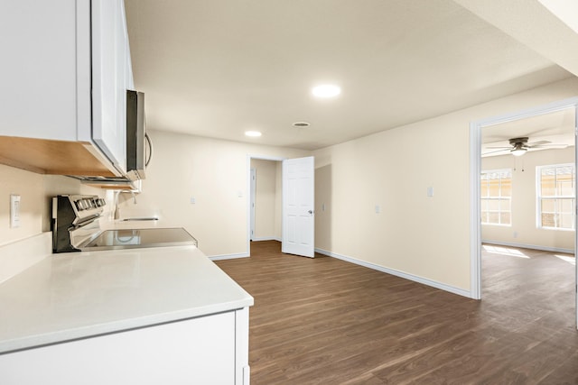 kitchen with stainless steel appliances, white cabinetry, dark hardwood / wood-style floors, and ceiling fan