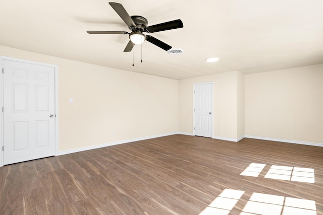 spare room featuring hardwood / wood-style floors and ceiling fan