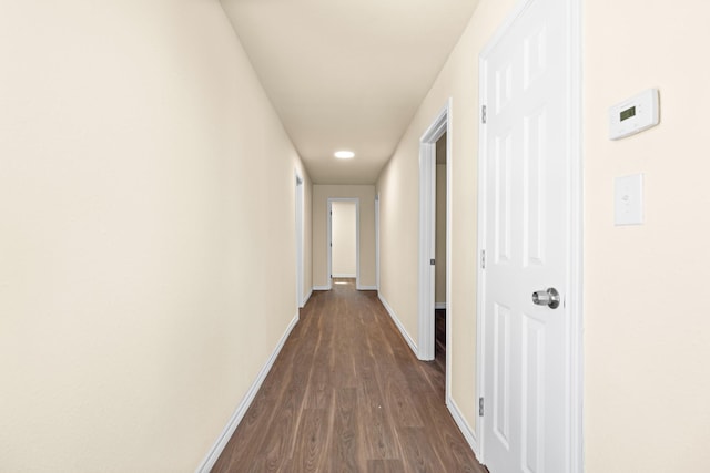 hall with dark hardwood / wood-style flooring