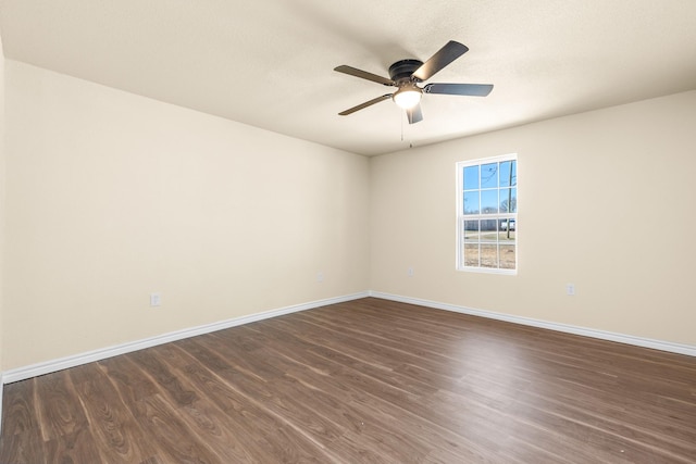 empty room featuring ceiling fan and dark hardwood / wood-style flooring