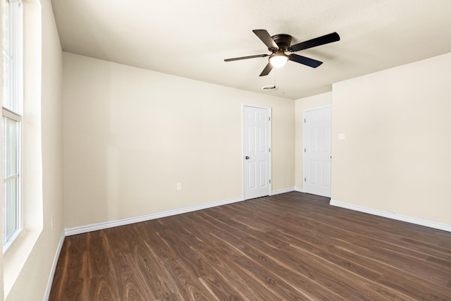 spare room with ceiling fan and dark hardwood / wood-style flooring