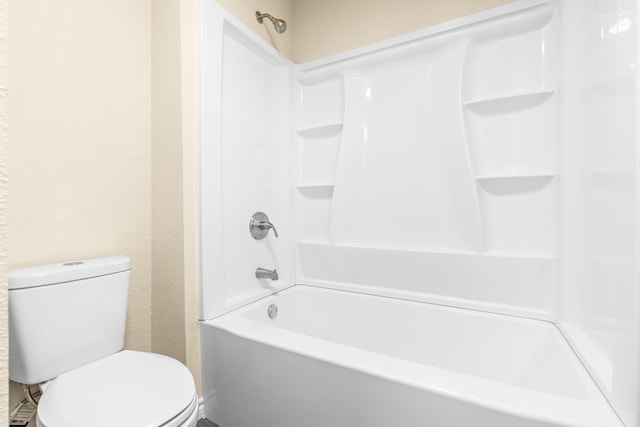 bathroom featuring shower / washtub combination and toilet