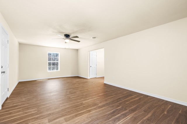 spare room featuring dark hardwood / wood-style floors and ceiling fan