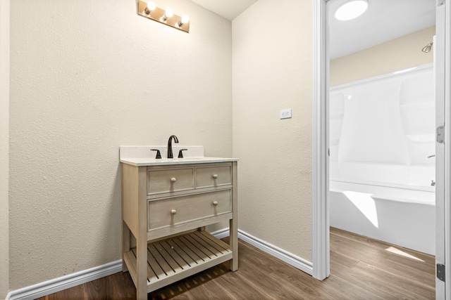 bathroom featuring hardwood / wood-style flooring and vanity