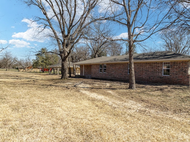 view of side of property featuring a yard