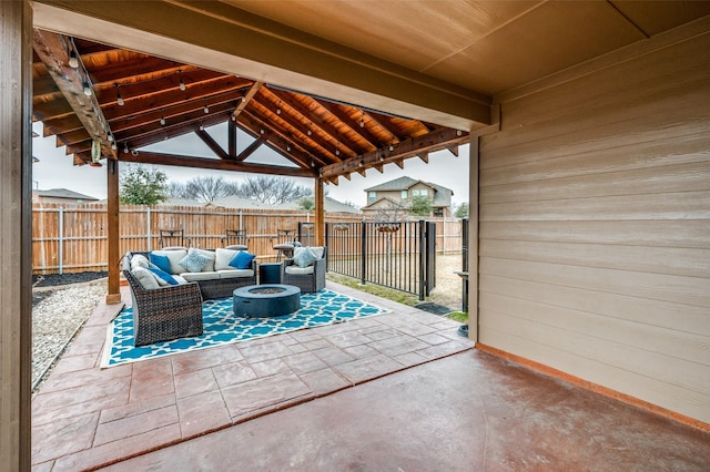 view of patio / terrace featuring a gazebo and an outdoor living space with a fire pit