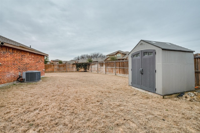 view of yard featuring central AC and a shed