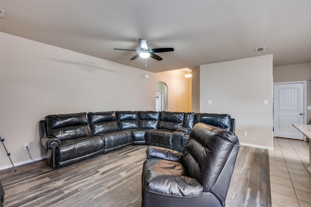 living room with hardwood / wood-style flooring and ceiling fan