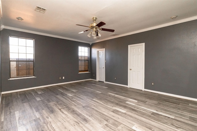 empty room with hardwood / wood-style flooring, crown molding, and ceiling fan