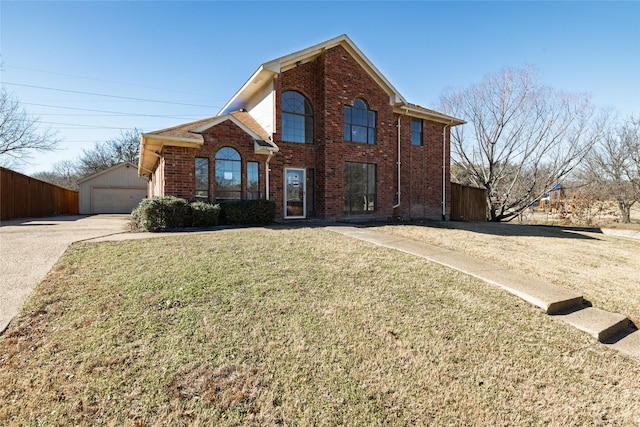 view of front property featuring a garage, an outdoor structure, and a front yard