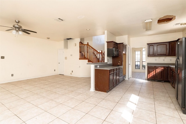 kitchen with dark brown cabinets, black appliances, ceiling fan, and light tile patterned flooring