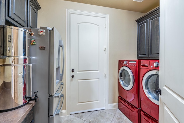 laundry area featuring light tile patterned flooring, independent washer and dryer, and cabinets