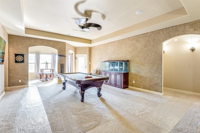 playroom with ceiling fan, billiards, a tray ceiling, and light colored carpet