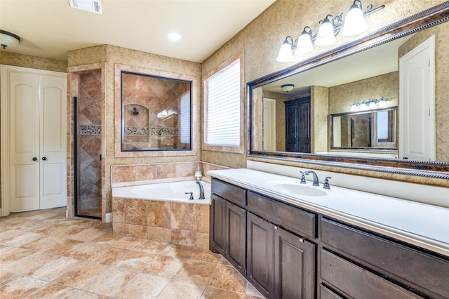 bathroom featuring vanity and shower with separate bathtub