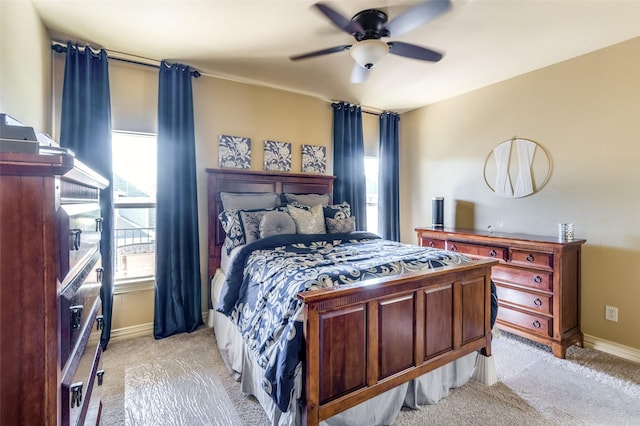 bedroom featuring light carpet and ceiling fan