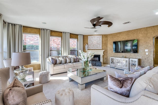 carpeted living room with ceiling fan