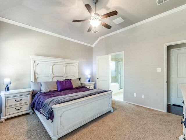 carpeted bedroom with crown molding, lofted ceiling, ensuite bathroom, and ceiling fan