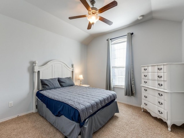 carpeted bedroom with ceiling fan and vaulted ceiling