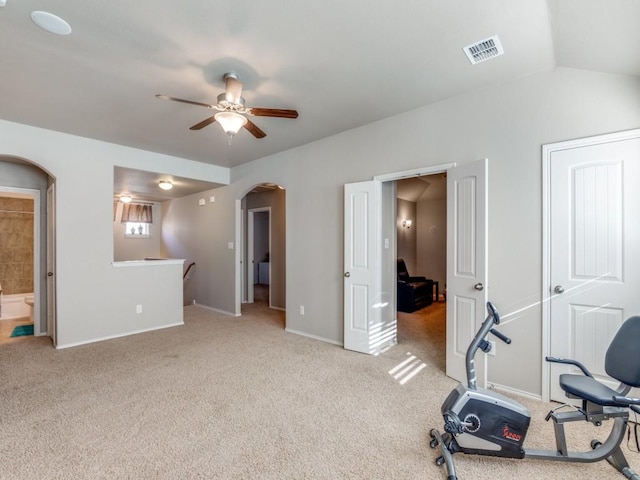 exercise room with light carpet, lofted ceiling, and ceiling fan