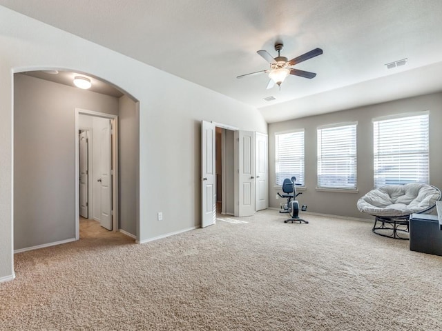 unfurnished room featuring ceiling fan, vaulted ceiling, and light carpet