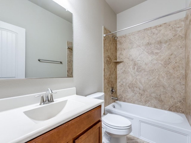 full bathroom with vanity, tiled shower / bath combo, and toilet