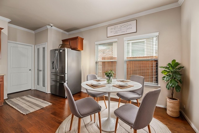 dining room featuring baseboards, ornamental molding, and dark wood-type flooring