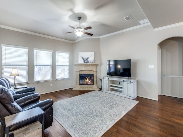 living room featuring a high end fireplace, ornamental molding, and dark hardwood / wood-style floors