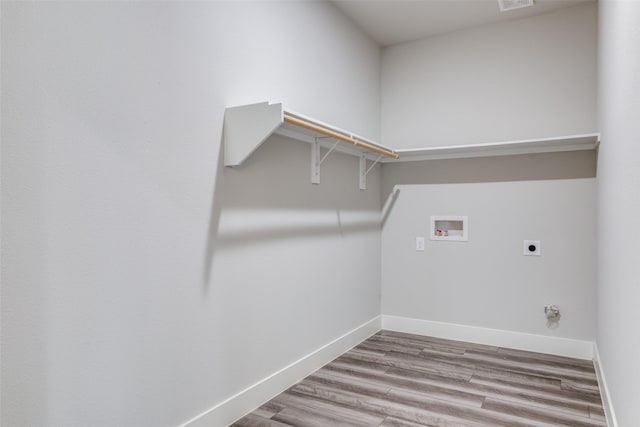 laundry room featuring washer hookup, hardwood / wood-style floors, and electric dryer hookup